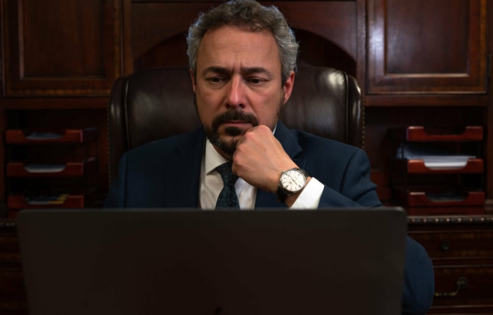 Emmanuel Meimaris, Immigration Attorney working on a laptop at Meimaris Law