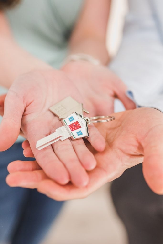 house key in couple's hands