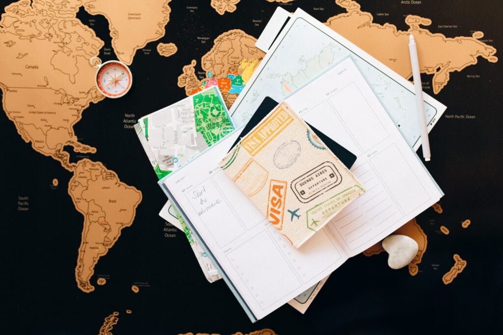 A map of the world on top of a notebook.